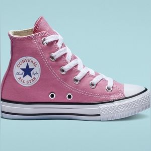 Girls pink converse high tops.
